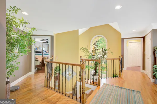 a large bed sitting in a bedroom next to a window