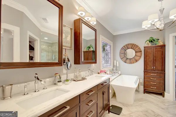 a spacious bathroom with a double vanity sink mirror and a shower