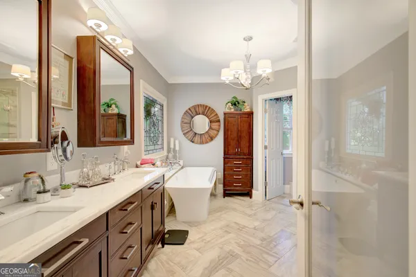 a living room with a mirror and a chandelier