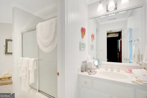 a bathroom with a sink vanity and mirror