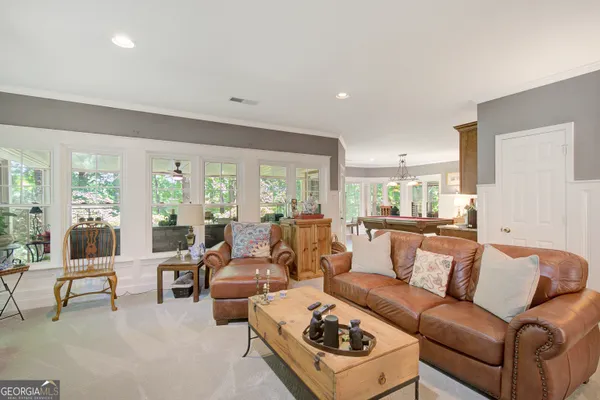 a living room with furniture and white walls