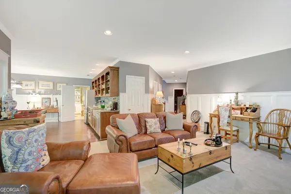a kitchen with a stove and wooden floor