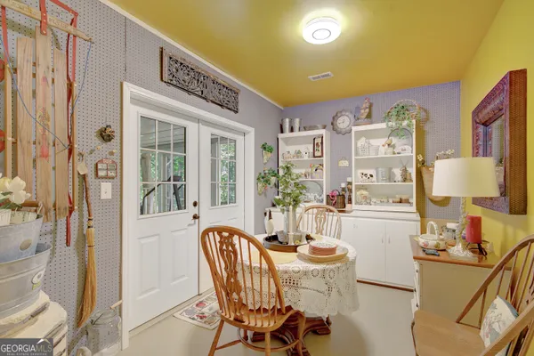 a view of a dining room with furniture large windows and wooden floor