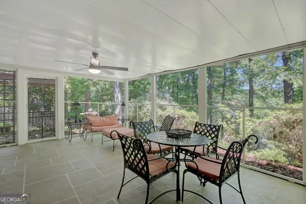 a room with lots of windows and furniture