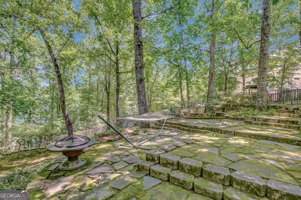 a view of backyard with a table and chairs