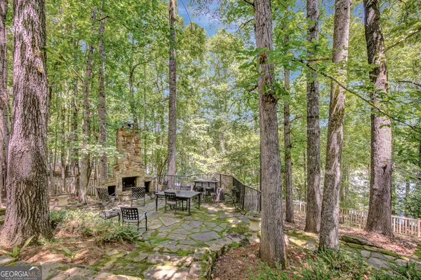 a view of house with a yard and sitting area