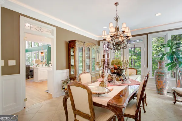a dining room with furniture a chandelier and a rug