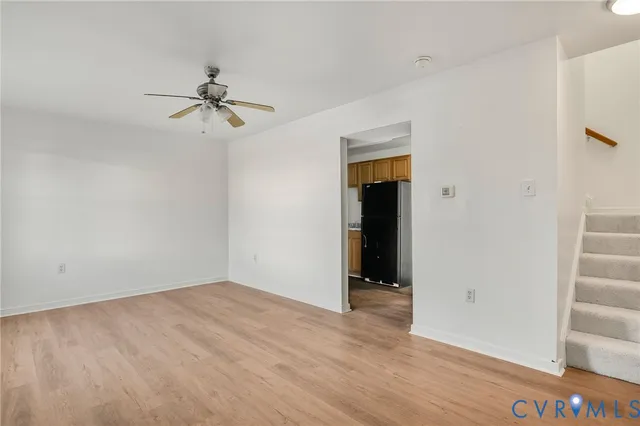 a view of room with hardwood floor and ceiling fan