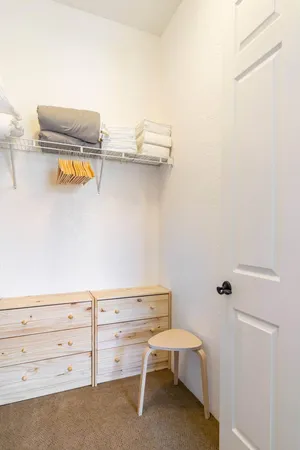 a utility room with cabinets and wooden floor