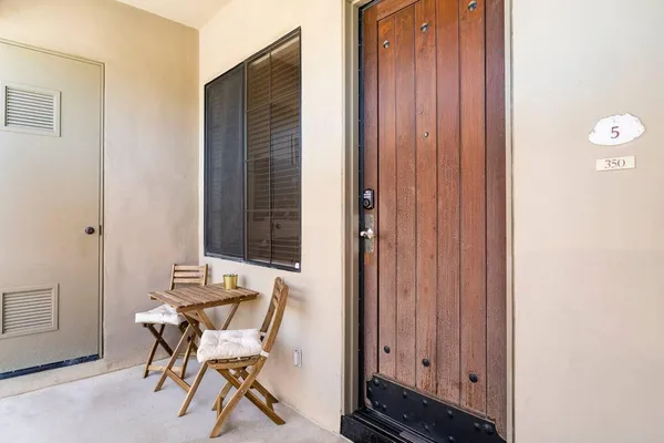 a view of a room that has a bed and a chair in it