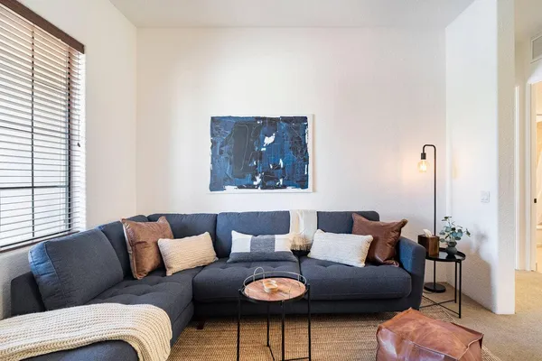 a living room with furniture and wooden floor