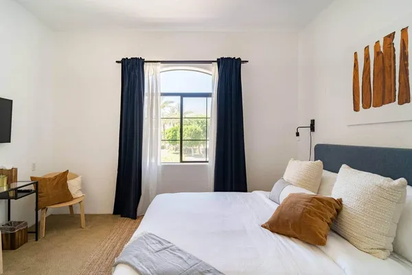 a bedroom with a bed and a window