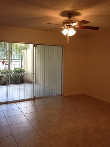 a view of a livingroom with a floor to ceiling window and chandelier