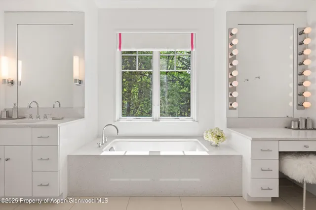a bathroom with bathtub sink and mirror