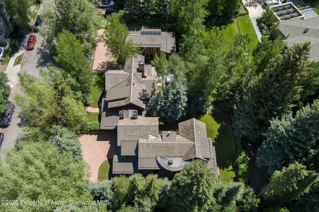 an aerial view of a house with a yard and garden