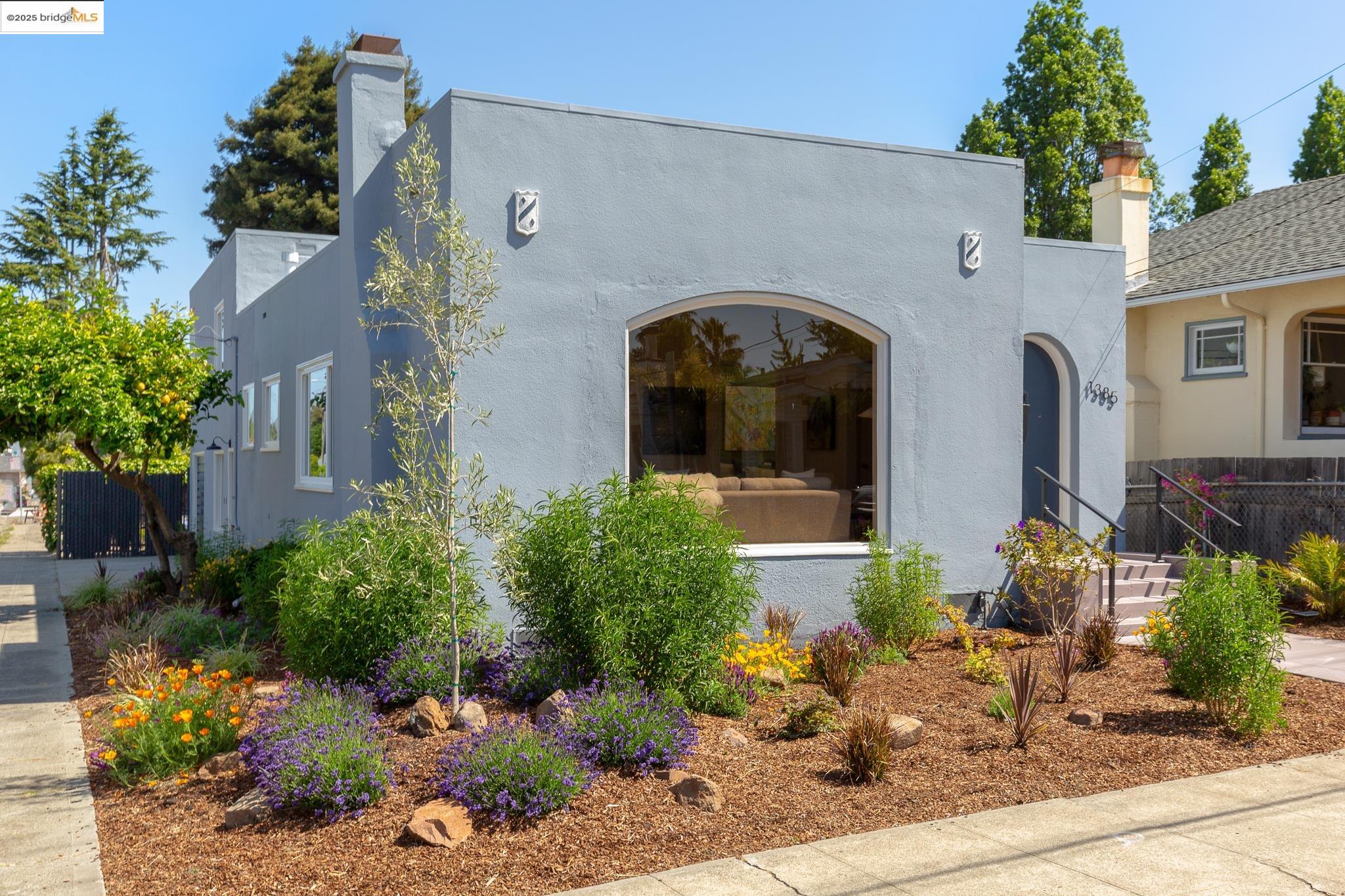 1385 Virginia Street Berkeley, CA 94702 - Photo 1 of 1 a front view of a house with lots of flowers planted