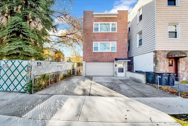 a view of a house with a tree and wooden fence