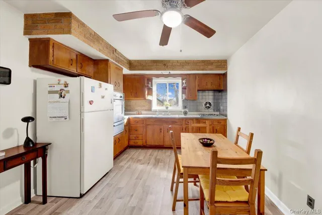 a kitchen with a table chairs refrigerator and microwave