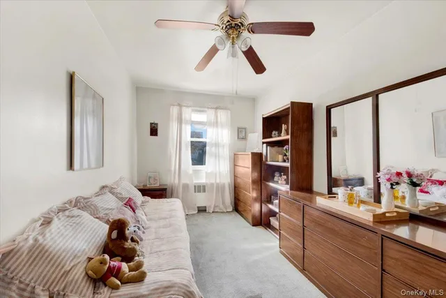a bed room with a bed furniture and a flat tv screen