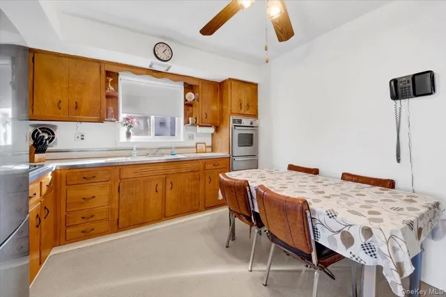 a kitchen with a table chairs sink and cabinets