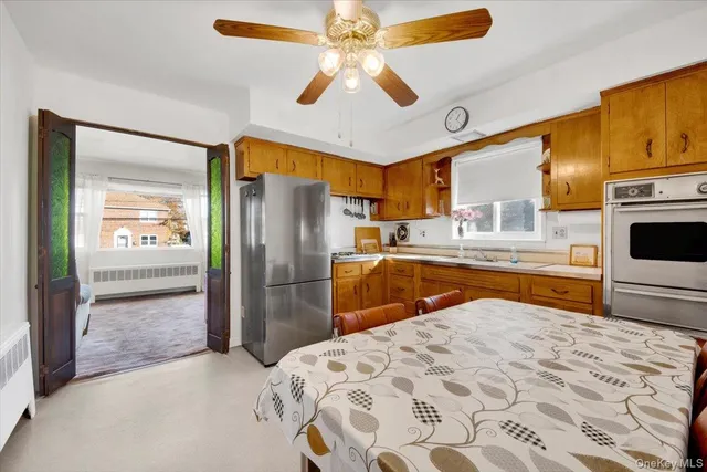 a large white kitchen with a stove a sink and a refrigerator