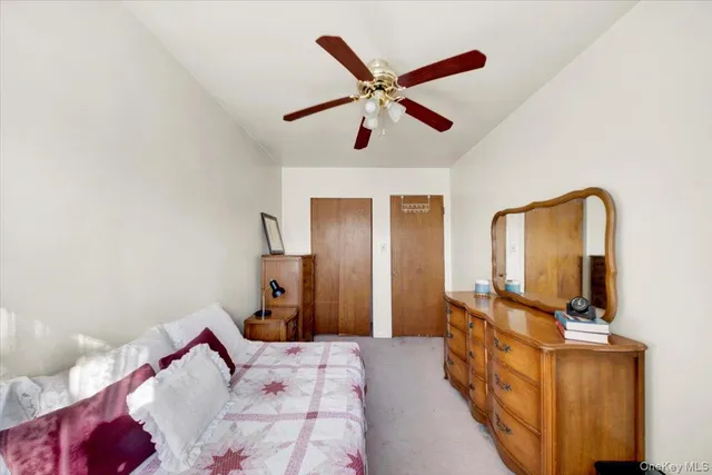 a bedroom with a bed with the view of hallway