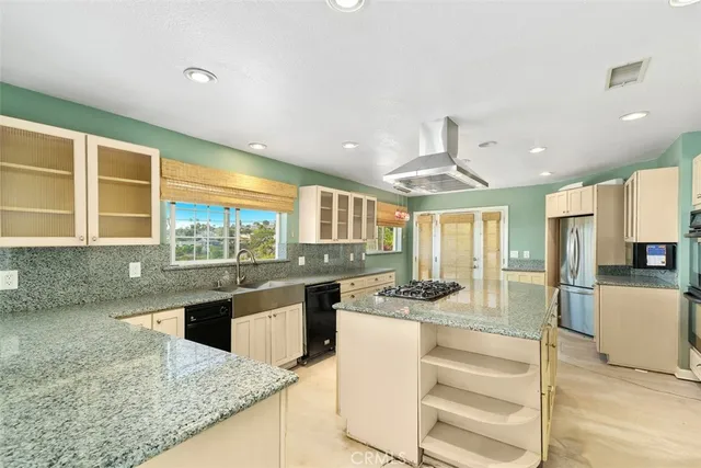 a large kitchen with stainless steel appliances granite countertop a stove and a sink