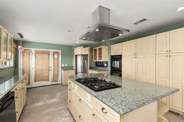 a kitchen with granite countertop kitchen island and stainless steel appliances