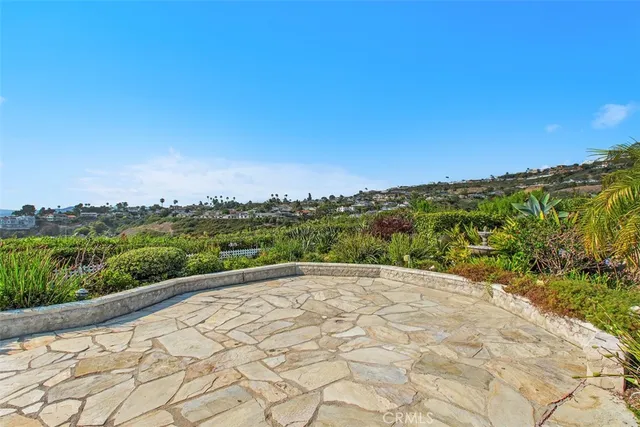 a front view of a house with a yard and potted plants
