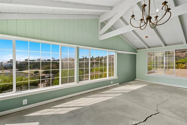 an empty room with a bathroom and a mirror