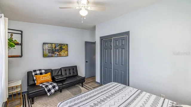 a bedroom with a bed and wooden floor
