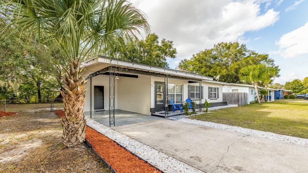 1406 South Conway Road Orlando, FL 32812 - Photo 2 of 30 a view of a house with backyard and trees