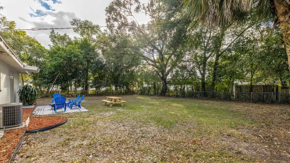 1406 South Conway Road Orlando, FL 32812 - Photo 23 of 30 a backyard of a house with table and chairs