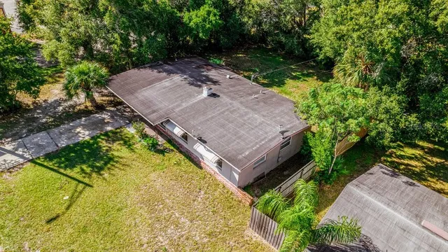 an aerial view of a house with a yard