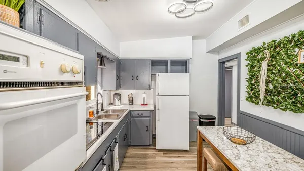 a kitchen with a refrigerator a stove top oven a sink and dishwasher
