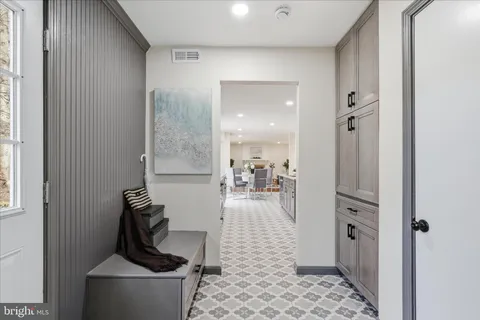 a living room with furniture a rug and a painting on the wall