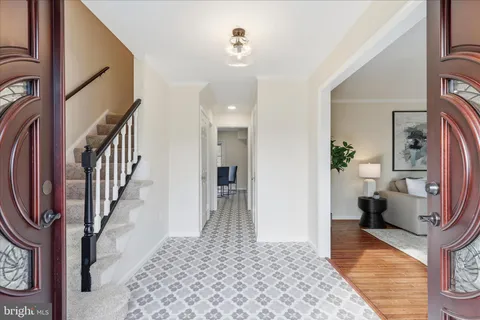 a view of a hallway with wooden floor and staircase