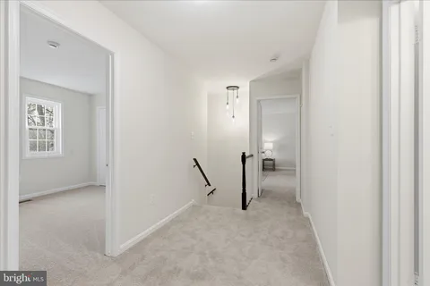 a spacious bedroom with a bed and a window