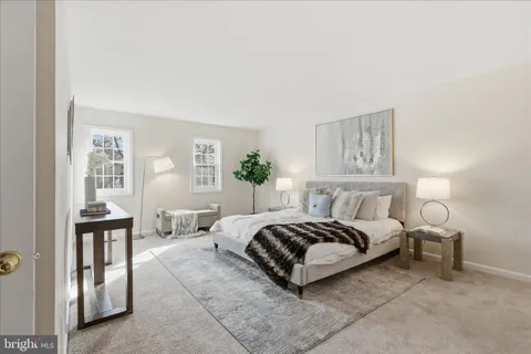 a bedroom with a bed window and couch