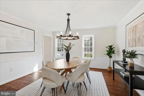 a view of a dining room with furniture wooden floor and a chandelier