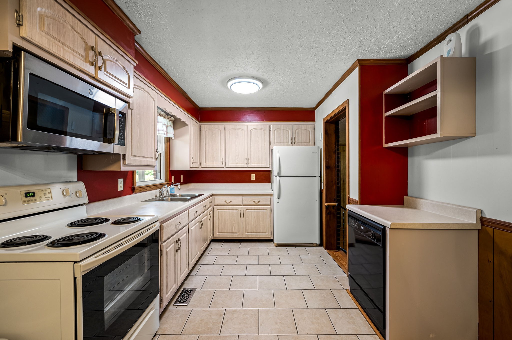 324 Jim Courtney Road Portland, TN 37148 - Photo 14 of 28 a kitchen with a stove sink and a refrigerator