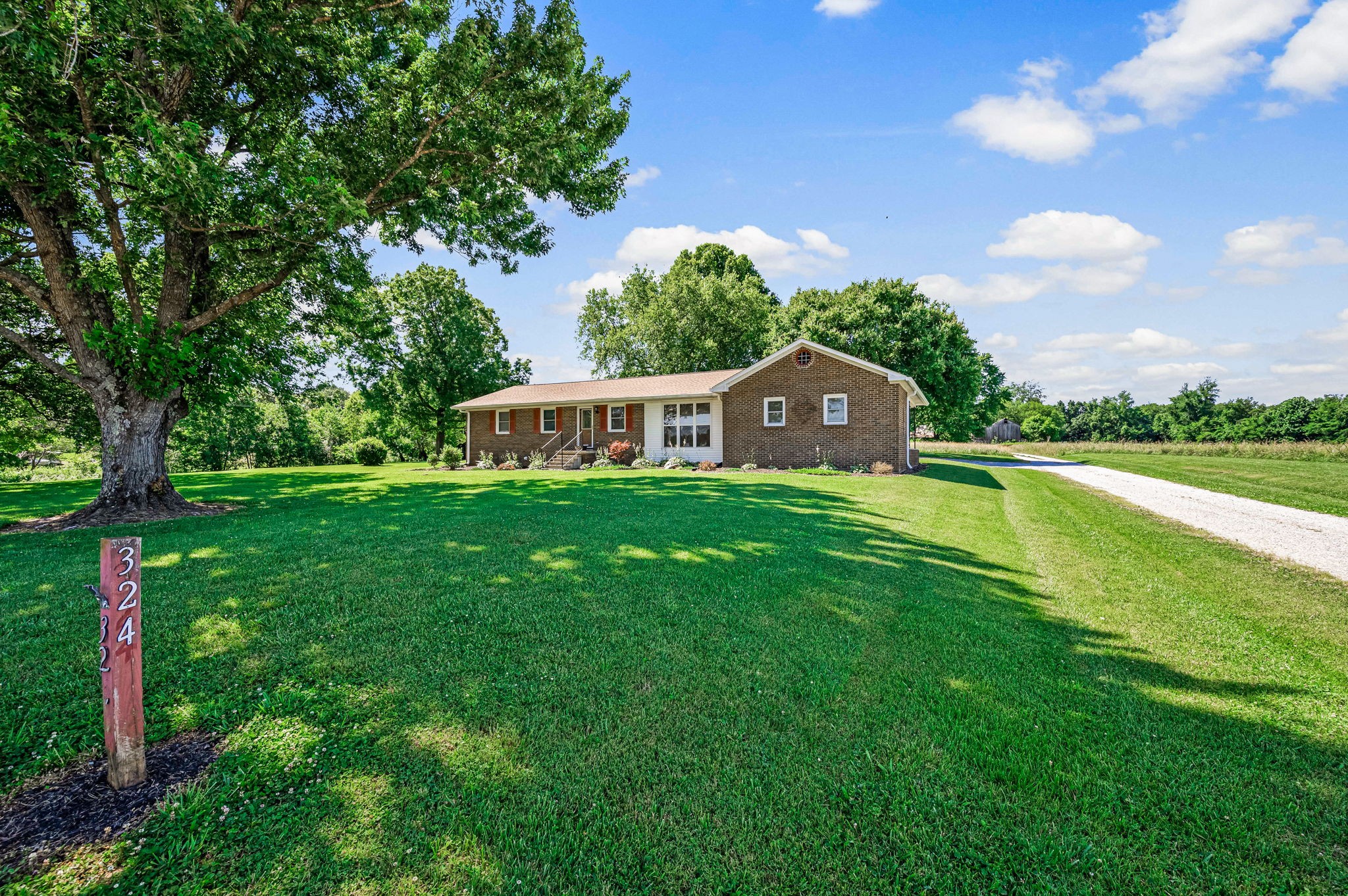 324 Jim Courtney Road Portland, TN 37148 - Photo 2 of 28 a house view with a garden space