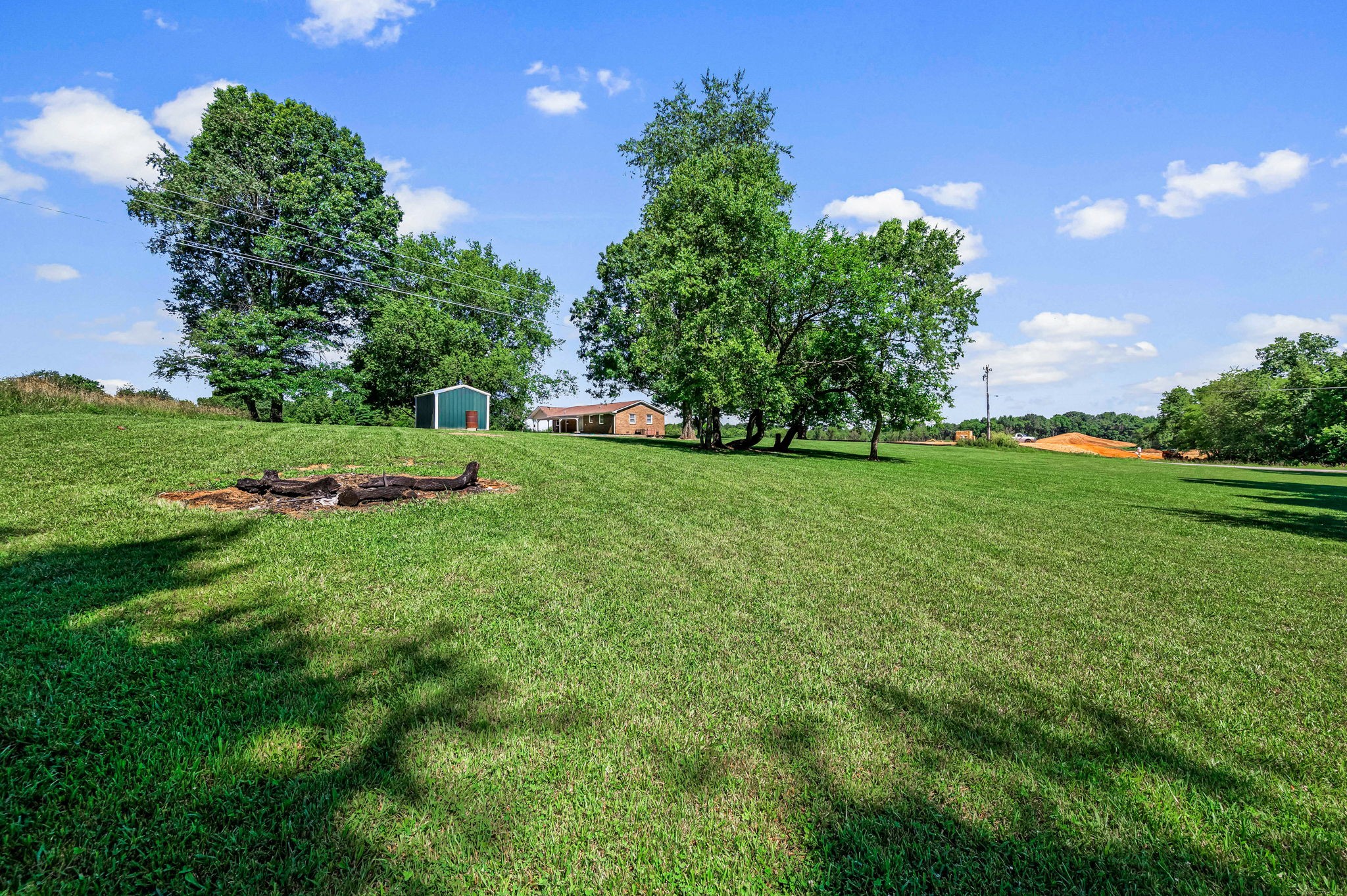 324 Jim Courtney Road Portland, TN 37148 - Photo 27 of 28 a view of a grassy field with trees