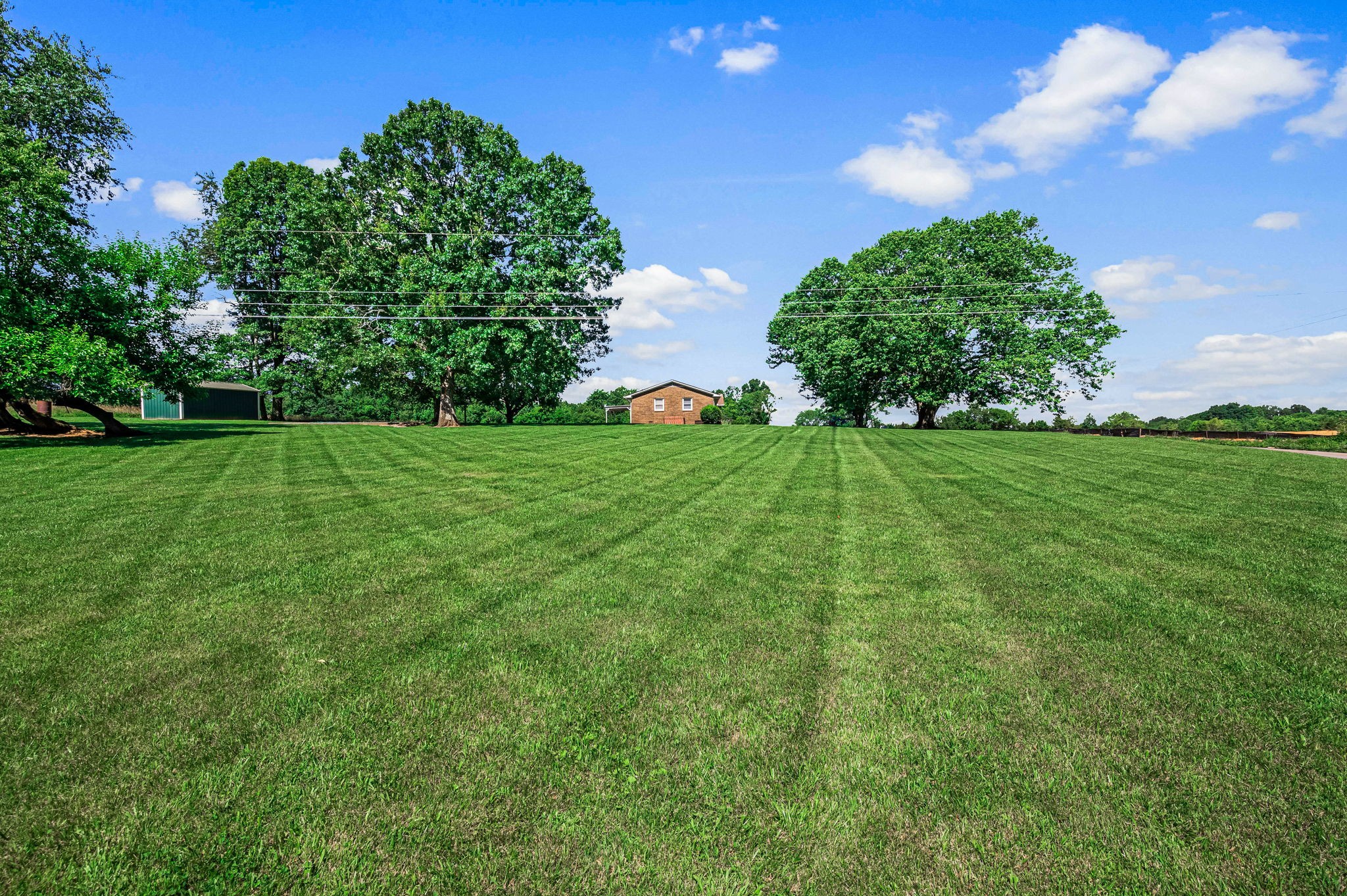 324 Jim Courtney Road Portland, TN 37148 - Photo 28 of 28 a view of a big yard with plants and a garden