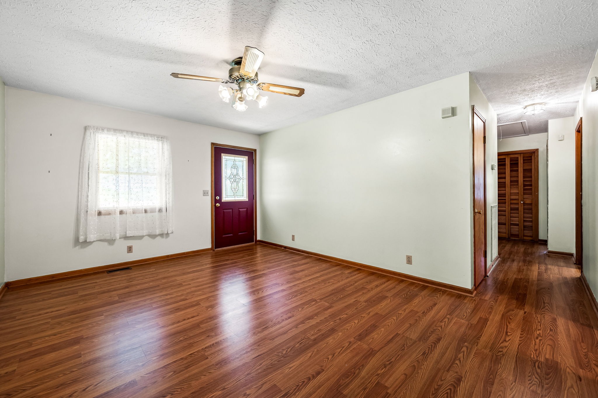 324 Jim Courtney Road Portland, TN 37148 - Photo 6 of 28 a view of an empty room with wooden floor and a window