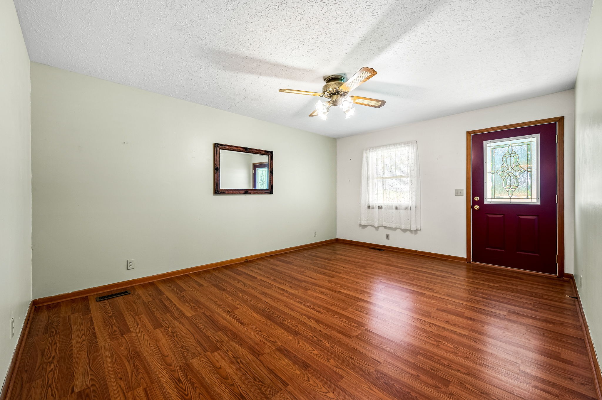 324 Jim Courtney Road Portland, TN 37148 - Photo 7 of 28 a view of empty room with wooden floor and fan