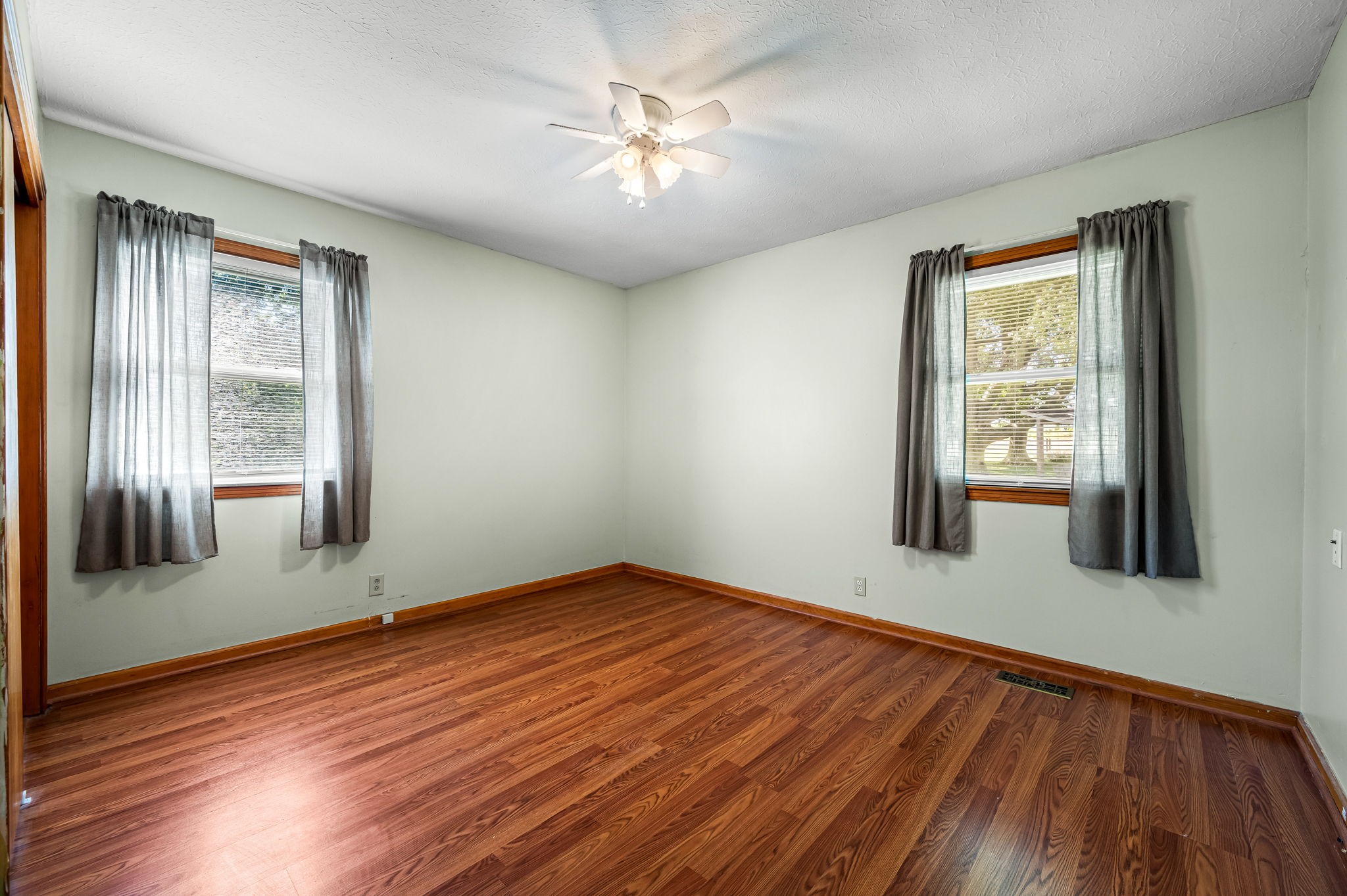 324 Jim Courtney Road Portland, TN 37148 - Photo 8 of 28 a view of an empty room with window and wooden floor