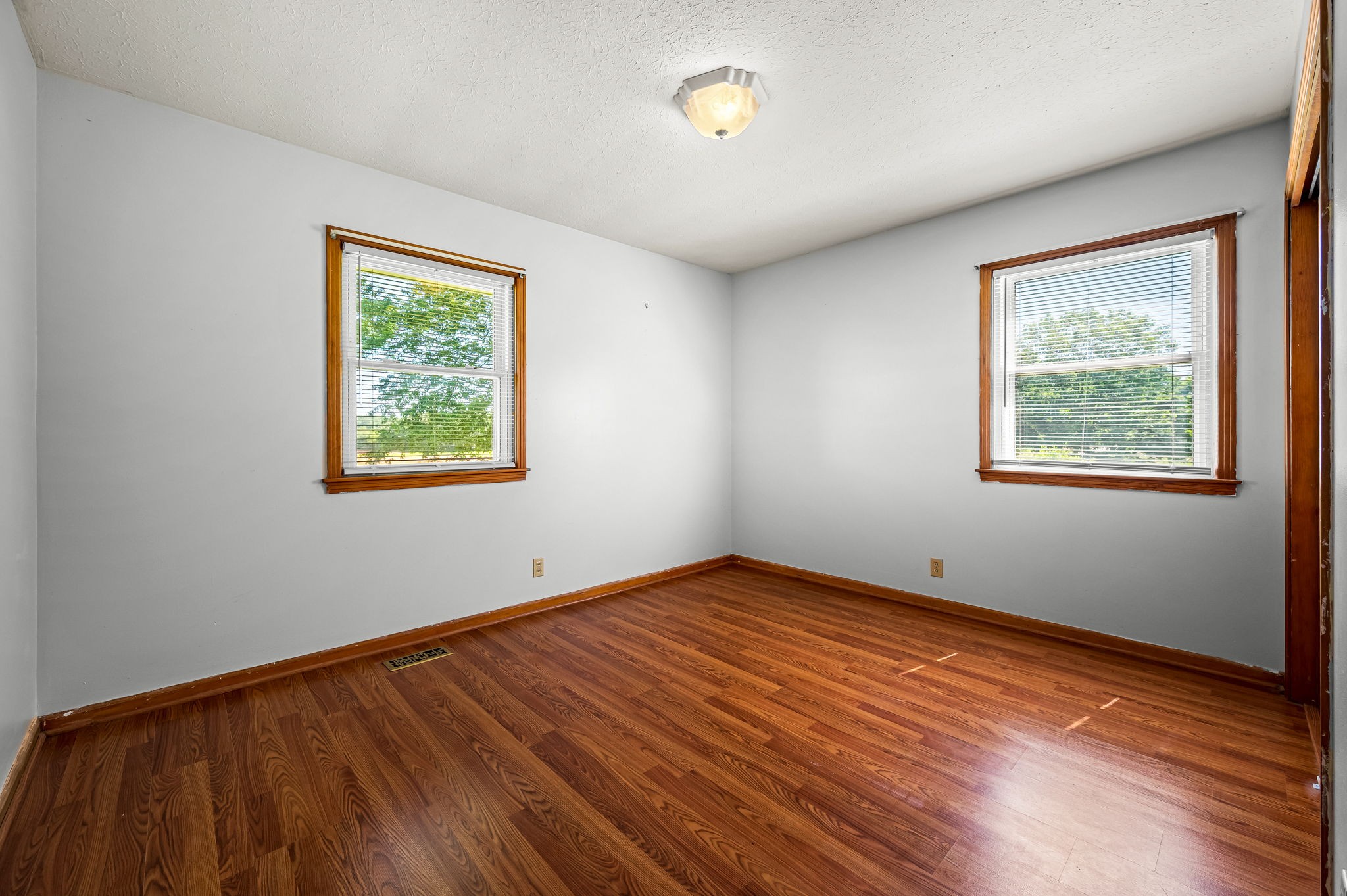 324 Jim Courtney Road Portland, TN 37148 - Photo 10 of 28 a view of an empty room with wooden floor and a window