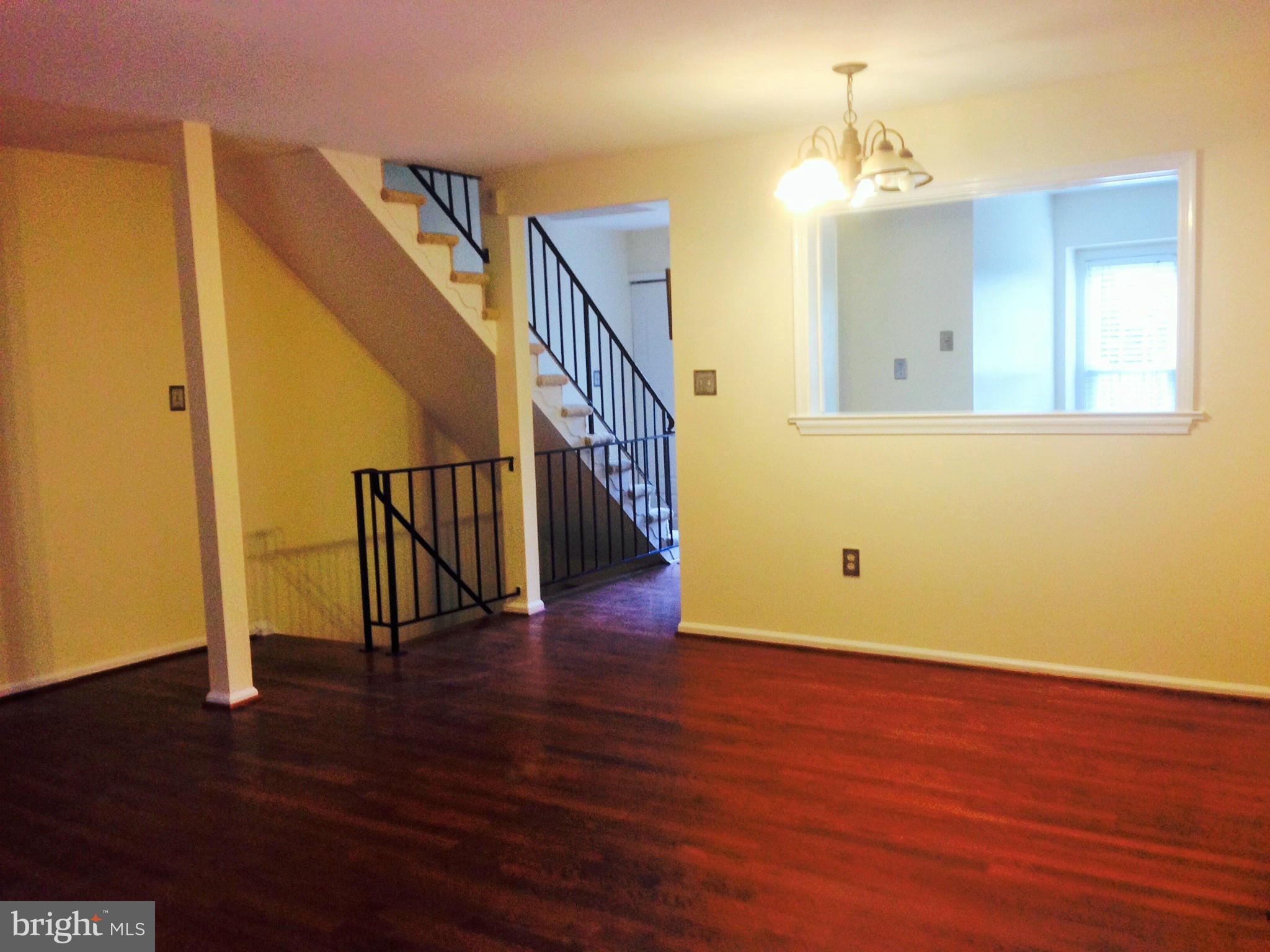 7933 Pebble Brook Court Springfield, VA 22153 - Photo 6 of 18 a view of a room with wooden floor and staircase