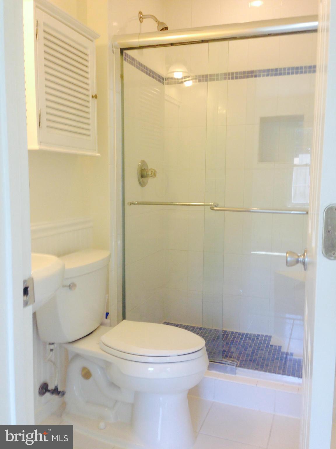 7933 Pebble Brook Court Springfield, VA 22153 - Photo 10 of 18 a bathroom with a toilet a sink and shower